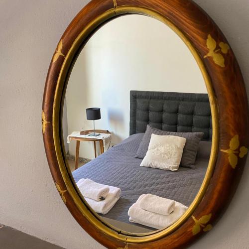 a bedroom with a bed with a mirror on it at Sayani Posada in Chilecito