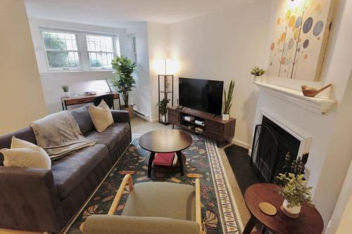 a living room with a couch and a fireplace at Capitol Hill & Penn - Steps from Eastern Market in Washington, D.C.