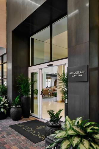 an entrance to a building with plants in a courtyard at La Concha Key West, Autograph Collection in Key West