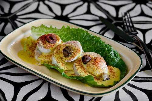 a plate of food with meat and lettuce on a table at La Concha Key West, Autograph Collection in Key West