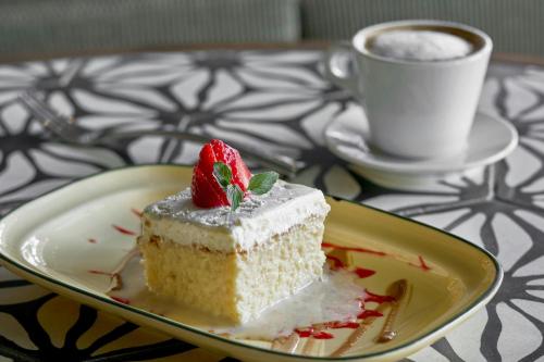 a piece of cake on a plate with a cup of coffee at La Concha Key West, Autograph Collection in Key West