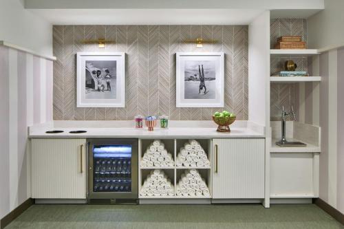 a kitchen with a counter with a wine cellar at La Concha Key West, Autograph Collection in Key West