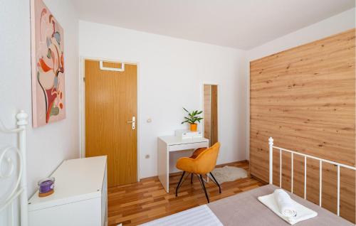a bedroom with a bed and a desk and a chair at 3 Bedroom Cozy Home In Brisevo in Briševo