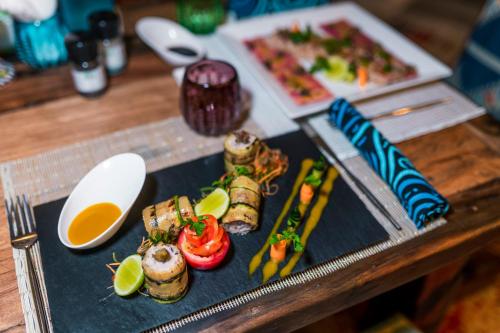 a tray of food on a table with food at Casa Paradis Boutique Hotel in Jambiani
