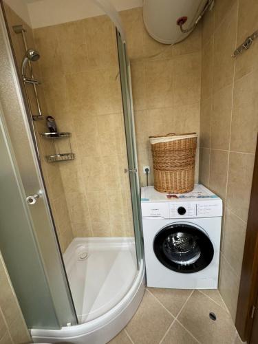 a bathroom with a washing machine and a washer at Pirin Golf View Apartment Bansko in Bansko