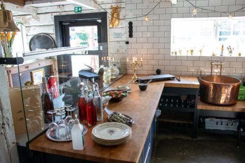a kitchen with a wooden counter with dishes on it at Hem till Gården boutique hotel in Västerås