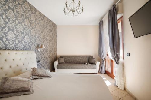 a bedroom with a bed and a couch at Giramondo LuxeFierairport in Fiumicino