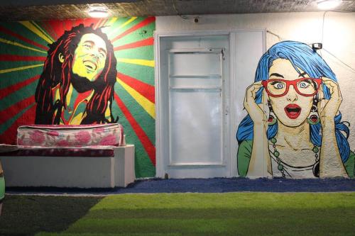 a wall with a mural of a woman with glasses at Castle Hotel in Cairo
