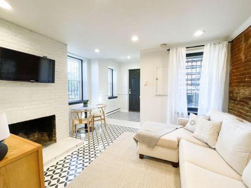 a living room with a couch and a fireplace at Charming and Historic Apartment in Capitol Hill in Washington, D.C.