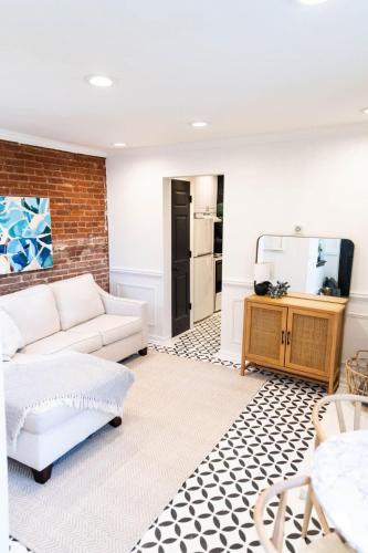 a living room with a couch and a tv at Charming and Historic Apartment in Capitol Hill in Washington, D.C.
