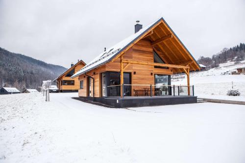 a log cabin in the snow with snow covered ground at Chata FONGRUB in Mýto pod Ďumbierom