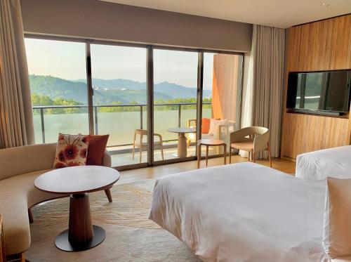 a hotel room with a bed and a large window at ANA InterContinental Beppu Resort & Spa by IHG in Beppu
