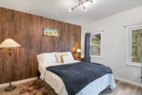 a bedroom with a bed and a wooden wall at USNA Home In Downtown Annapolis in Annapolis