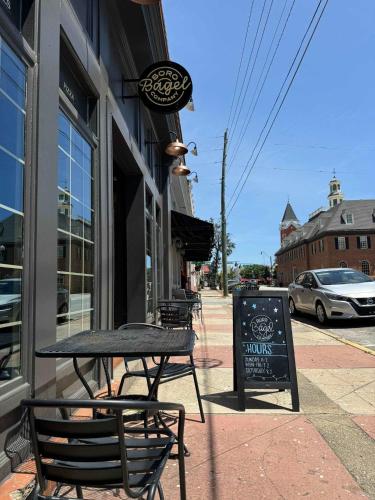 a table and chairs sitting outside of a restaurant at Eagle Exec Loft In Downtown Statesboro in Statesboro