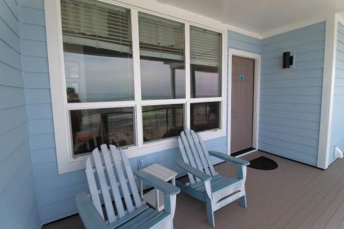 two chairs sitting on the porch of a house at Beautiful Sunrise in Folly Beach