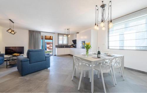 a living room with a table and a blue chair at 3 Bedroom Stunning Home In Tkon in Tkon