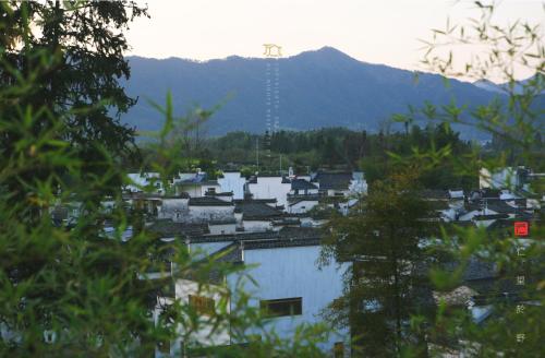 a view of a city with a mountain in the background at Standing in the wild in Xiwu