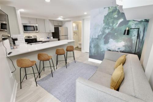 a living room with a couch and a kitchen at Darling Apartment in Capitol Hill - TWO min to Metro in Washington, D.C.