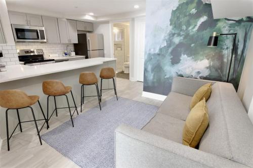 a living room with a couch and a kitchen at Darling Apartment in Capitol Hill - TWO min to Metro in Washington, D.C.