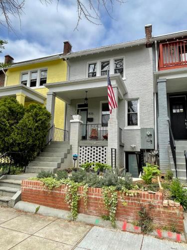 a house with an american flag in front of it at Darling Apartment in Capitol Hill - TWO min to Metro in Washington, D.C.