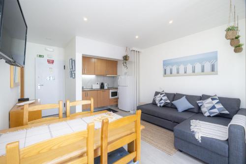 a living room with a couch and a table at Bay View by OCvillas in Albufeira