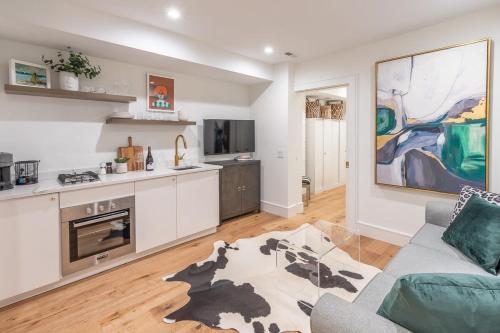 a living room with a couch and a kitchen at Delightful Apt in the Heart of Dupont in Washington, D.C.