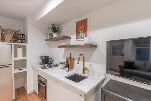 a kitchen with a sink and a counter top at Delightful Apt in the Heart of Dupont in Washington, D.C.