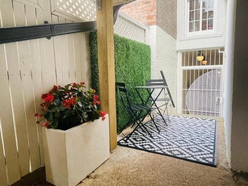 a porch with a plant and a table and chairs at Delightful Apt in the Heart of Dupont in Washington, D.C.