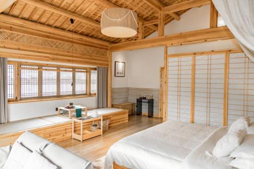 a bedroom with a white bed and a couch at Standing in the wild in Xiwu