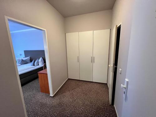 a room with a couch and a door to a bedroom at Hotel Victoria in Bad Kreuznach