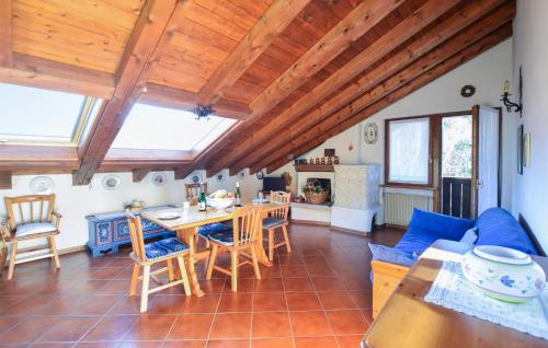 a living room with a blue couch and a table at Lovely Apartment In San Vito Di Cadore in San Vito di Cadore