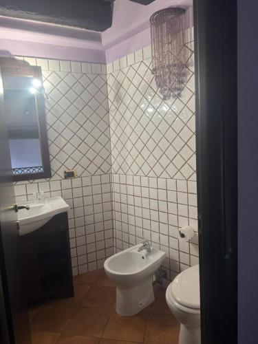 a bathroom with a sink and a toilet and a mirror at Residenza Sant'Andrea in Campobasso