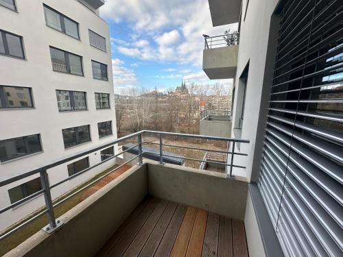 a balcony of a building with a view of the city at Apartment VAŇKOVKA in Brno