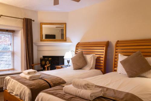 a hotel room with two beds and a mirror at The Frenchgate Bed and Breakfast in Richmond