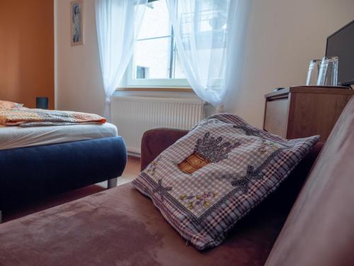 a bedroom with a pillow sitting on a bed at PENZION BENEŠOV u BROUMOVA in Broumov