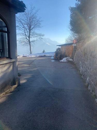 an empty street next to a building with a stop sign at Belle Maison au cœur des alpes in Leysin