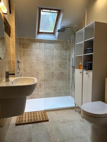a bathroom with a tub and a sink and a toilet at The Cottage, Upper Linney, Ludlow in Ludlow