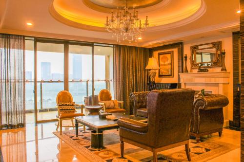 a living room filled with furniture and a chandelier at Ramada Plaza By Wyndham Fuzhou South in Fuzhou