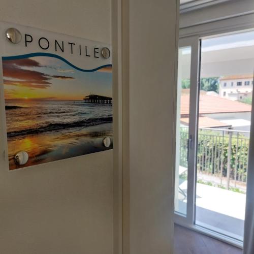 a door to a room with a sign on it at Slowersilia Bed and Breakfast in Lido di Camaiore