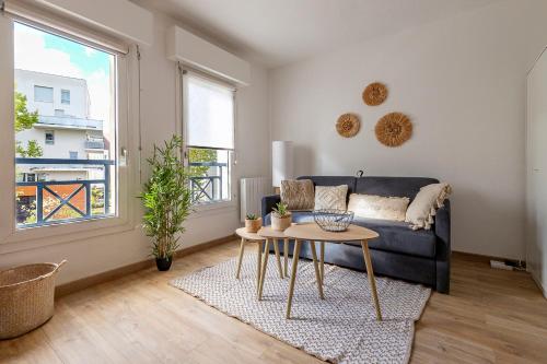 un salon avec un canapé et une table dans l'établissement Bright and charming studio next to the tram, à Toulouse
