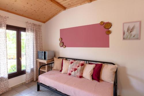 a room with a couch with pillows on it at Agreste Agriturismo in Sassoferrato