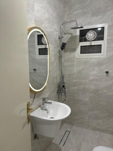 a bathroom with a sink and a mirror at شقة أرضية عائلية مكونة من غرفتين نوم وصالة ومطبخ 3 in Riyadh