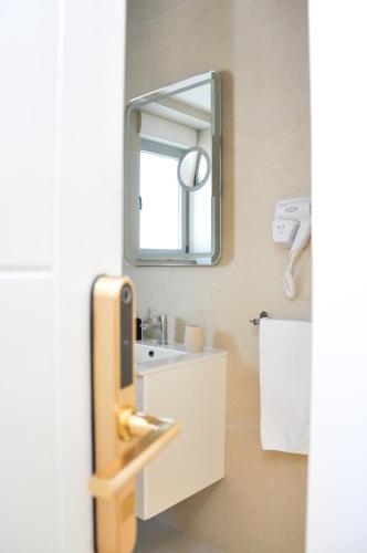 a bathroom with a sink and a mirror at Boutique Hostel Livia in Metković