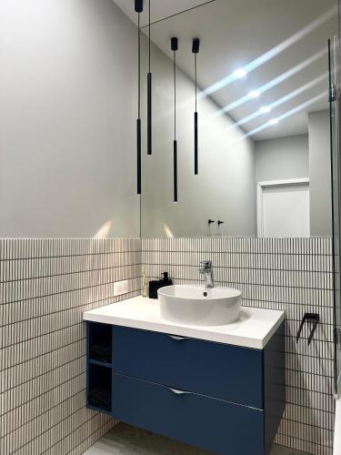 a bathroom with a sink and a mirror at Odrzańska 17B Apartment - Self Check-In 20h in Wrocław