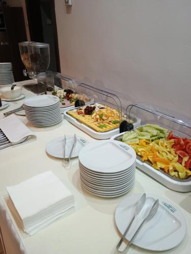 a table with plates and bowls of food on it at Hotel Auto Jas in Nitra