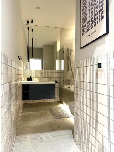 a bathroom with a sink and a toilet and a mirror at Odrzańska 17B Apartment - Self Check-In 20h in Wrocław