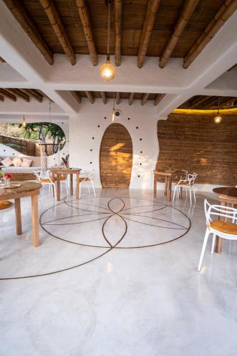 a room with tables and chairs and a circle on the floor at Tierra Munay in Las Tunas