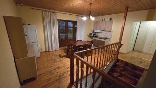 a room with a kitchen with a wooden floor at Märjamaa Hostel in Märjamaa