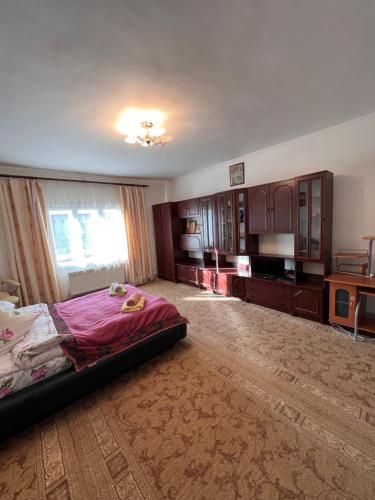 a large room with a bed and a window at Міні-готель Міраж in Yasinya