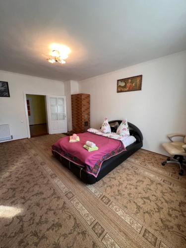 a bedroom with a large bed in a room at Міні-готель Міраж in Yasinya